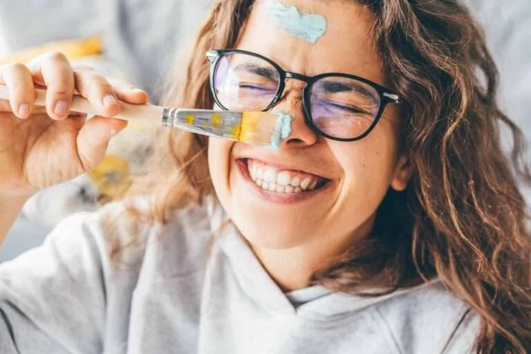 woman-with-paint-brush-laughing